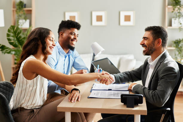 istock Young couple makes a deal with an agent in the office and does handshake 2065805596