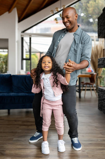 istock Happy father dancing at home with his daughter 2065808910