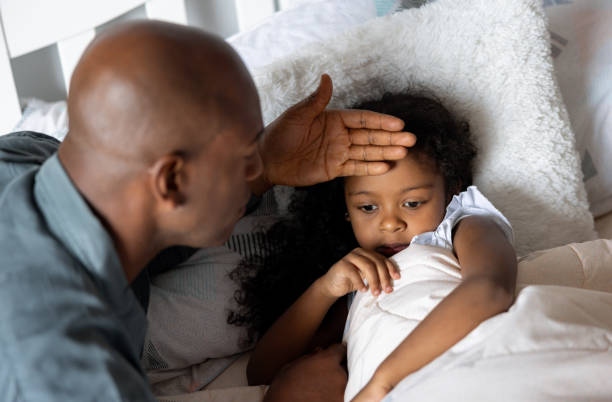 istock Father checking on his sick daughter at home 2065809439