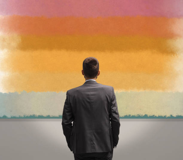 Man looking at paintings at the art exhibition