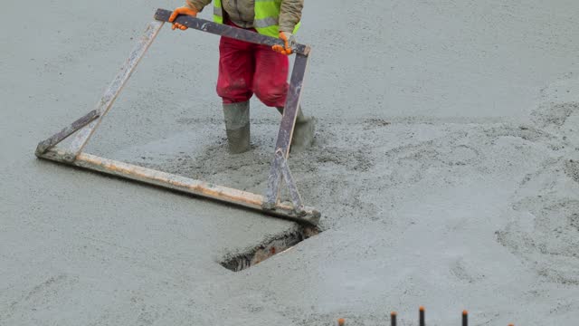 Workers laying Cement concrete