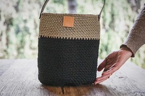 handmade crochet bag on wood table