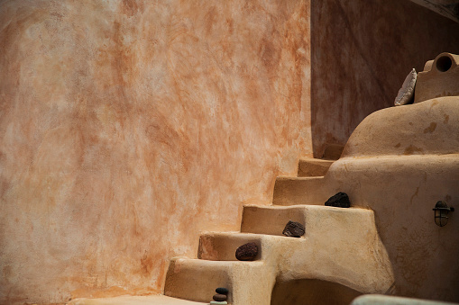 Warm, earth-colored steps rise in a traditional Mediterranean setting, inviting a sense of discovery.