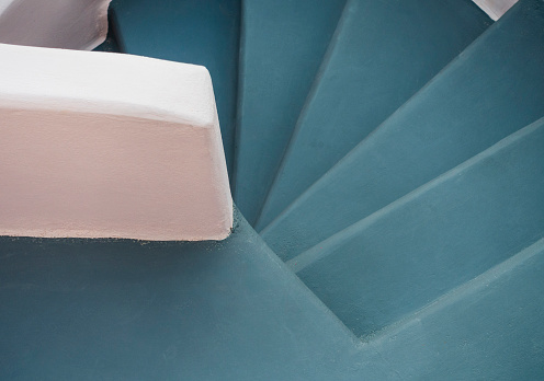 Minimalist composition of a stairwell in Santorini, featuring the iconic pastel hues of the Greek islands.