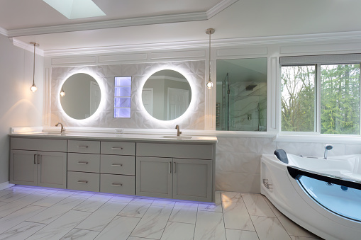 Spacious modern contemporary master bathroom with remodel of vanity and wall plus shelf with lights
