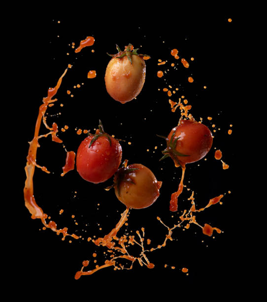 istock Tomatoes in red juice splash isolated on a black background 2065886241