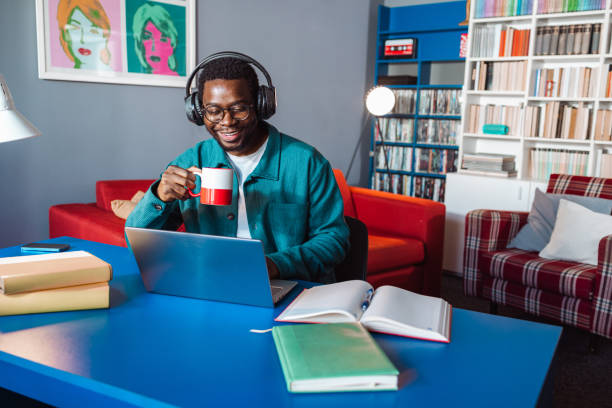 African American man sitting at the desk and using a laptop