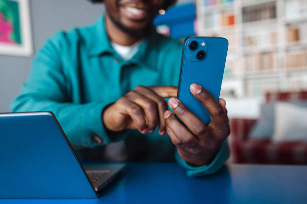 istock Close up of a young man using smart phone and a laptop 2065932026