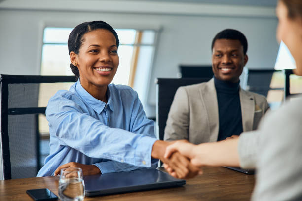 istock Smiling African businesswoman doing a handshake with a female client. 2065959191