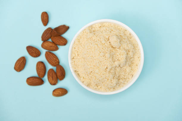 istock Almond flour and almonds on a blue background top view 2065964463