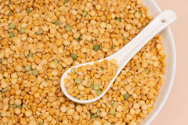 istock Pea yellow groats grains cereal in spoon close-up macro. 2065964490