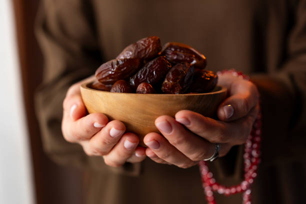 istock Dates fruit in a wooden bowl 2065973358
