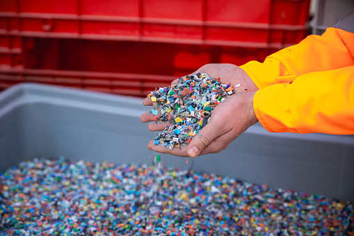 Plastic Resin pellets in holding hands.