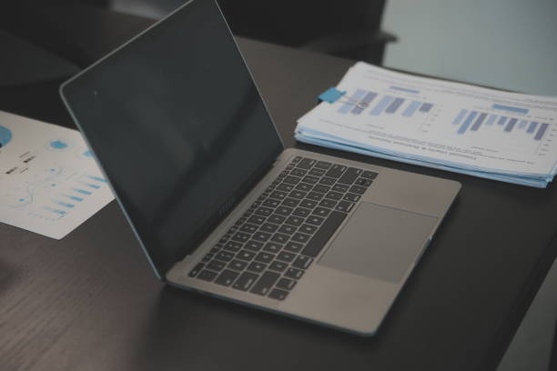 istock Laptop on a desk in an open financial office. 2065993862