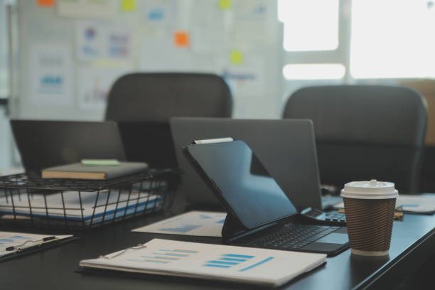istock Laptop on a desk in an open financial office. 2065995483