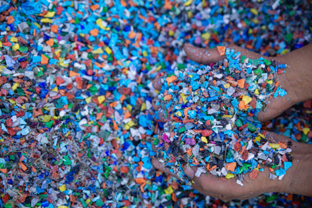 istock Plastic Resin pellets in holding hands. 2065996003