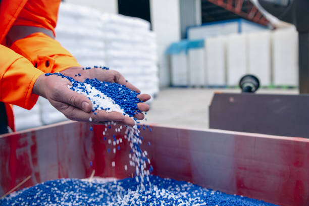 istock Plastic granules are poured from the hand 2066001791