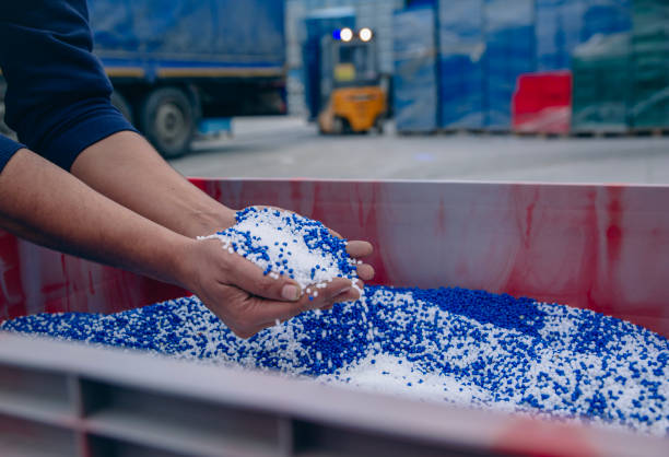 istock Plastic granules are poured from the hand. 2066003383
