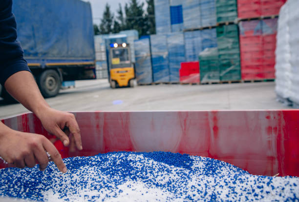 istock Plastic granules are poured from the hand. 2066004412
