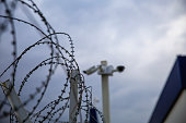 barbed-wire-fence-and-security-camera.jpg?b=1&s=170x170&k=20&c=CGHnIYmSInmZKOTLVLDCLr-sAqVRRAYbSD2qZ_wewro=