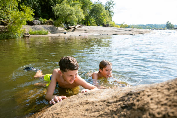 istock Friends swimming in the river 2066008621