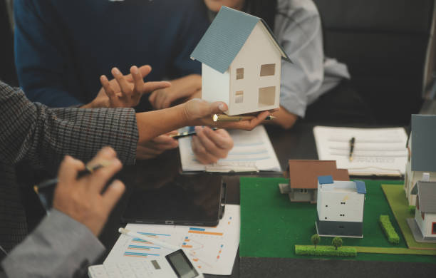 istock Team of architectures and businessmen discussing and brainstorming on floor plan modification for real estate investment and housing development project 2066024063