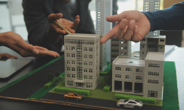 istock Team of architectures and businessmen discussing and brainstorming on floor plan modification for real estate investment and housing development project 2066028224