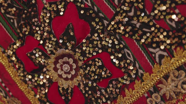 Close-up of fabric embellished with sequins and Asian patterns. Asian patterns. Traditional Asian handicrafts. 4K