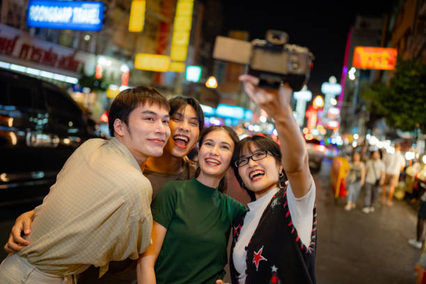 istock Group of Friends Enjoying a Night Stroll on Yaowarat Road. 2066086830