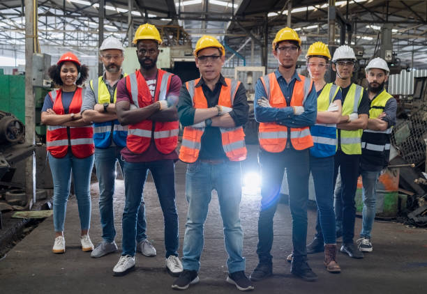 istock Team Workers and workers are standing in the factory. Team engineers and technician wearing protective standing in manufacturing. 2066087359