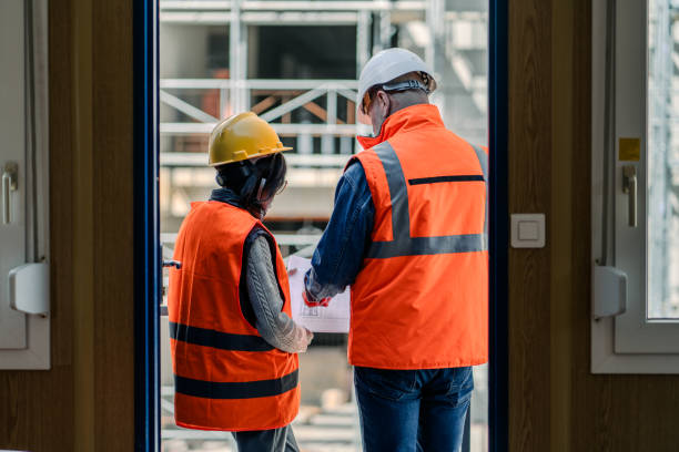 istock Workers Engaged in Discussion In Front of Construction Conteiner 2066121618
