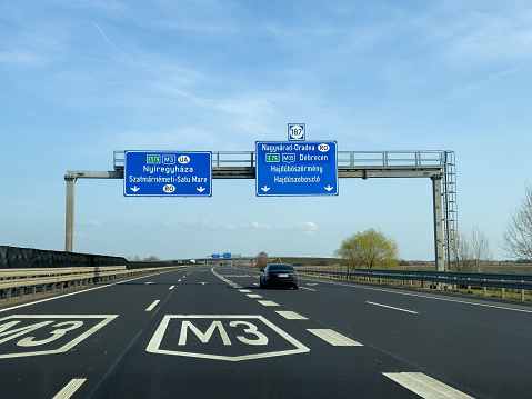 Closeup of 100 speed limit sign at dutch highway, blurred cars background - Netherlands (focus on sign)