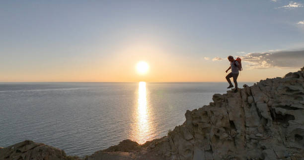 istock Mature man ascends rock ridge crest 2066150868
