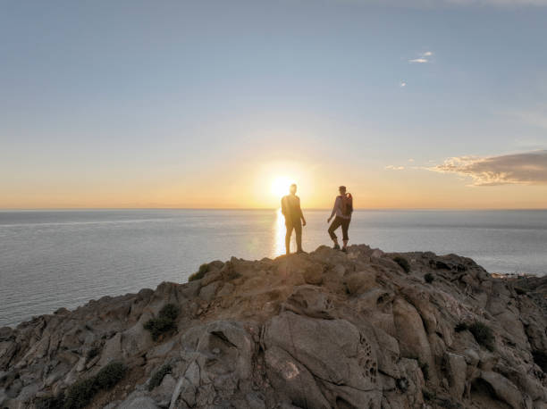 istock Mature couple ascend rock ridge crest 2066154608