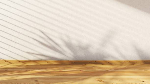 istock The blurred shadow of a palm tree and window blinds cast on a structural wall. Abstract background in minimalist style for product presentation. Wooden floor. Beige colors 2066165543