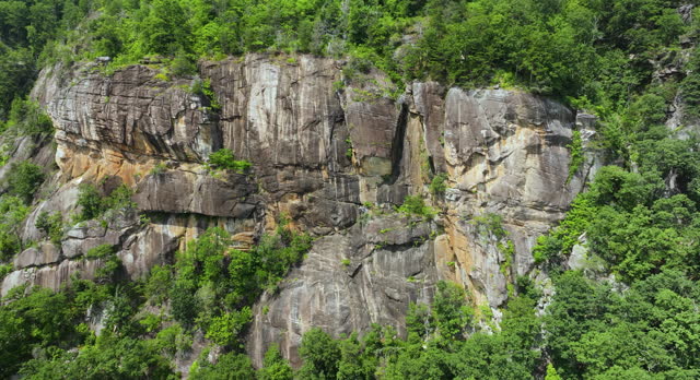 Aerial view of rocky mountain formation in Blue Ridge Mountains near Chimney Rock State Park. Geological features of cliff erosion