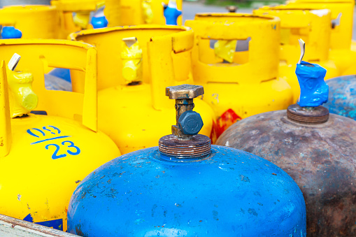Blue and yellow gas cylinders close up.