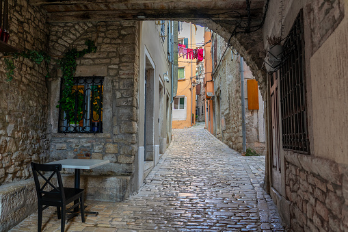 beautiful street of Rovinj Croatia with cobblestone looking through an arch tunel .