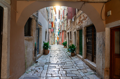 beautiful street of Rovinj Croatia with cobblestone looking through an arch tunel .