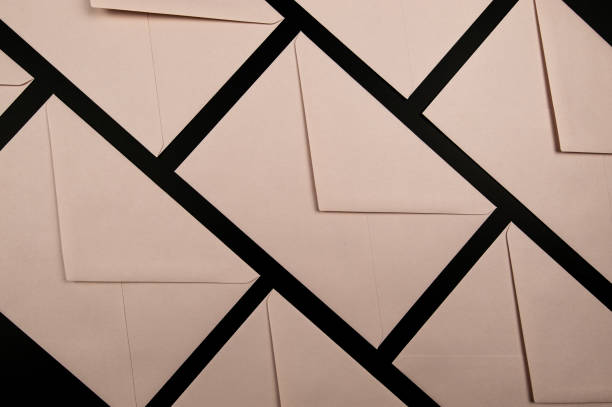 istock Top view of light pink envelopes on black background. 2066221530
