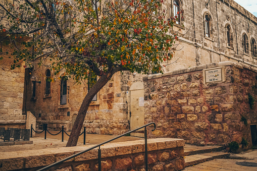 Cozy narrow small Street in the Old City of Jerusalem, Israel. Typical stoned houses and walls of jewish historic quarter area part.