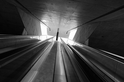long escalator, black and white, tunnel