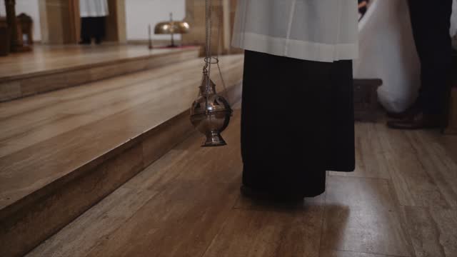 Priest With Catholic Thurible Swinging In Church