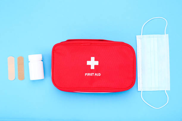 istock First aid kit with medical supplies on blue background 2066278472