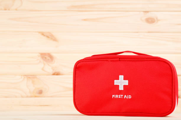 istock First aid kit on brown wooden background 2066291007