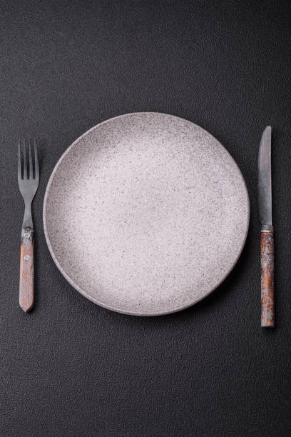 istock Cutlery fork, knife and spoon on a dark textured concrete background 2066318078