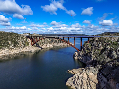 DCIM\\100MEDIA\\DJI_0551.JPGAn iron bridge towers over the reservoir, combining strength and beauty. The structure connects two banks, offering a breathtaking view of the water and the natural environment - Ricobayo in Zamora - Spain