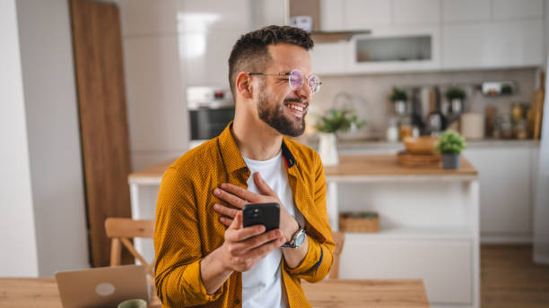 istock man with eyeglasses stand at home use mobile phone sms texting 2066319686