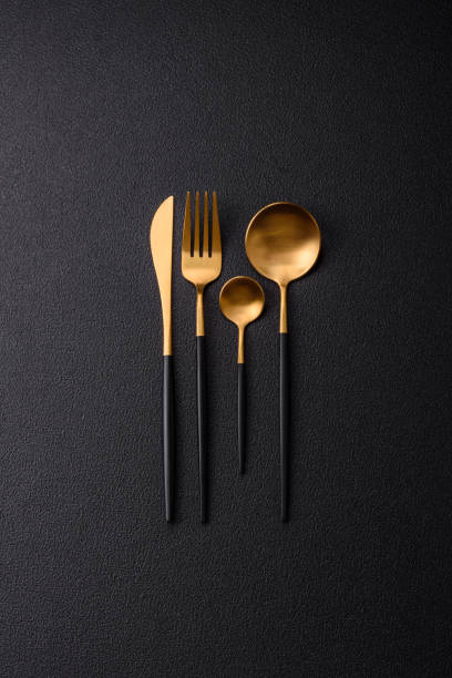 istock Cutlery fork, knife and spoon on a dark textured concrete background 2066325450