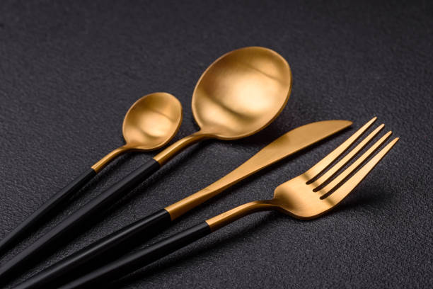 istock Cutlery fork, knife and spoon on a dark textured concrete background 2066325453